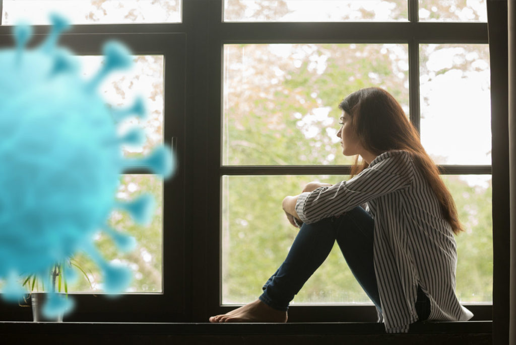 Collage of corona virus and a young woman sitting indoors and looking outside